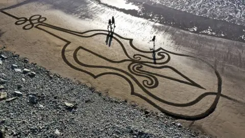 Sean Corcoran Sean Corcoran of The Art Hand made this piece of sand art on Kilmurrin Cove in Waterford as a tribute to Ashling Murphy.