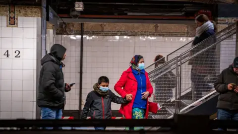 Getty Images Travellers wear medical masks at Grand Central station on March 5, 2020 in New York City