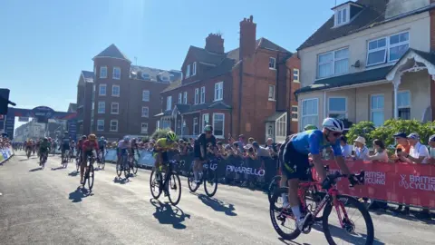 Cyclists who have crossed the finish line