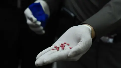 AFP A police officer displays yaba tablets, or methamphetamine mixed with caffeine, to the media on 1 February 2017.