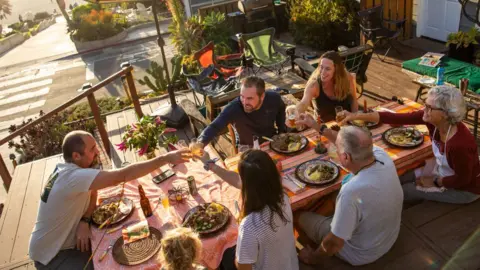 Getty Images The Liggett family dine outside in Manhattan Beach, California, on 26 November 2020