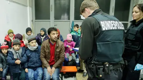 Getty Images German police registering migrants in Passau, 27 Jan 16