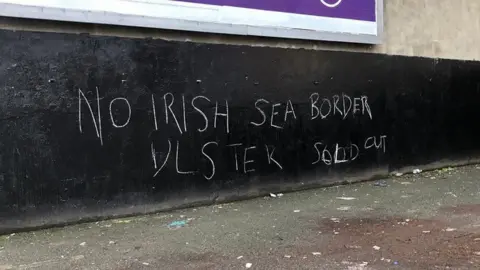 BBC Anti-Irish Sea border graffiti in Belfast