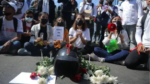 AFP People offer candles and flowers for the teenager who was shot on Tuesday