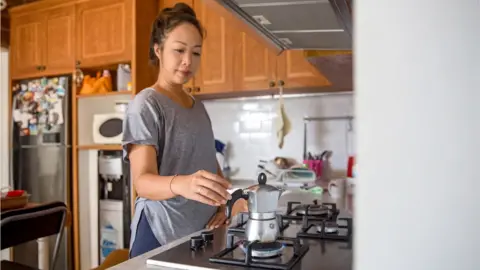 Getty Images Woman making an espresso on a gas hob