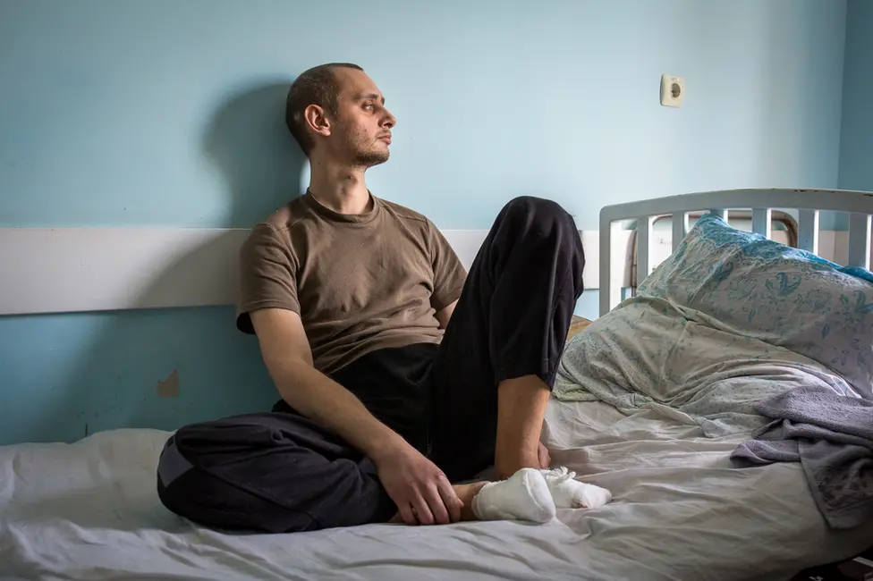 BBC Nikita Horban sits in a medical facility in Zaporizhzhya. "It still hurts," he said. "The wounds are still fresh."