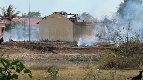 Getty Images Smoke billows from the warehouse following an explosion at an army base in Kampong Speu province