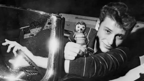 AFP/Getty Images This file photo taken in the 1960s shows French singer Johnny Hallyday in a car