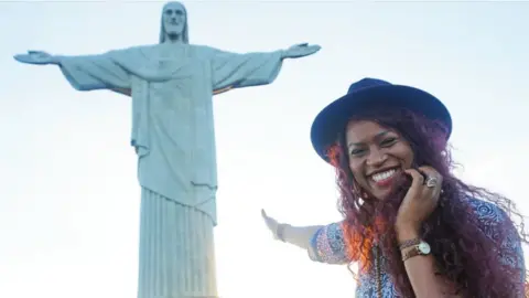 Gloria Atanmo Gloria points to the Jesus statue in Rio de Janiero