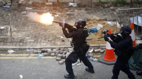 Reuters Hong Kong police fire tear gas at a protest in 2019