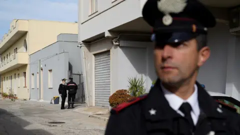 Reuters Carabinieri standing guard outside Messina Denaro's hideout in Campobello di Mazara