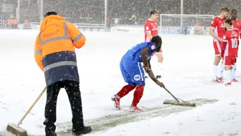 Rex Features A player at Peterborough United sweeping the pitch