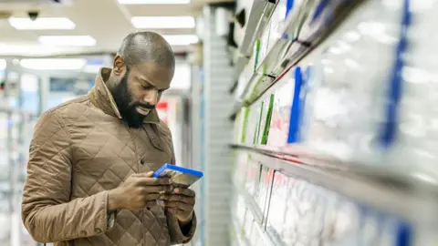 Getty Images A stock image of a man buying computer games