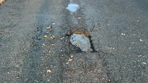 Teresa Gower Deep and poorly repaired potholes in Ridge Way, Edenbridge