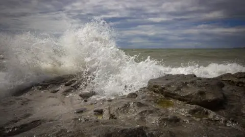 Mark Tugwell Waves crash on rocks at Ogmore-by-Sea, Vale of Glamorgan, captured by Mark Tugwell