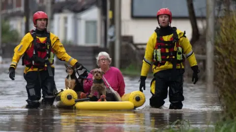 Getty Images A woman is rescued with her dogs in Nantgarw