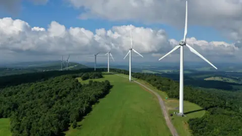 Getty Images A row of wind turbines on the ridge of a hill