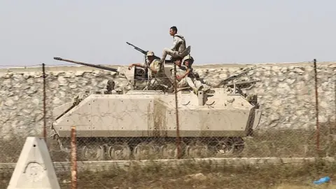 AFP File photo showing Egyptian soldiers patrol the Egypt-Gaza border (21 April 2016)