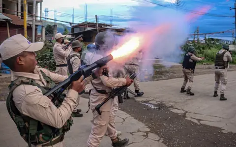 AFP A policeman fires tear gas to the protesters as they demand restoration of peace in India's north-eastern state of Manipur after ethnic violence, in Imphal on September 21, 2023