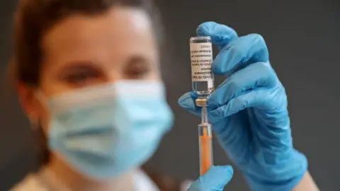 A pharmacist holding the vaccine