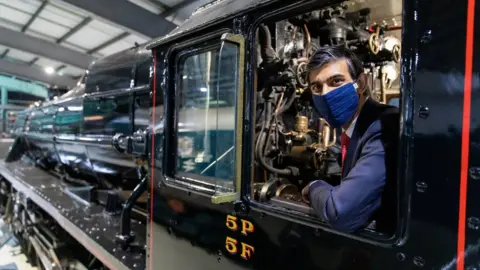 HM Treasury Rishi Sunak, wearing a face mask, pictured on a locomotive in 2021