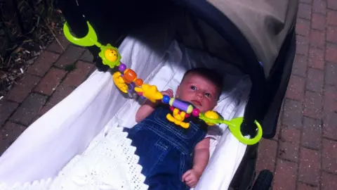 Young baby girl in a pram