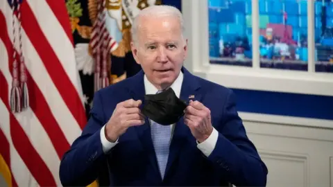 Getty Images US President Joe Biden removes his mask before speaking during a meeting with his administration's Supply Chain Disruptions Task Force and private sector CEOs.