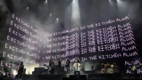 Getty Images Sam fender with lyrics behind him