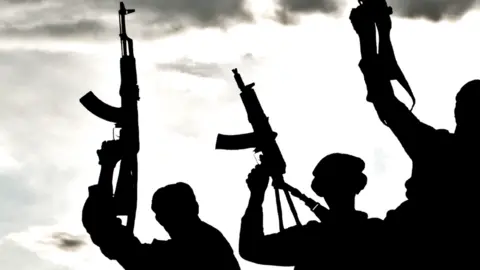 Getty Images Silhouetted gunmen - generic photo