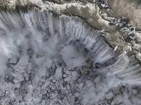 Anadolu Agency An aerial view of large snow-capped ice chunks at the foot of the falls