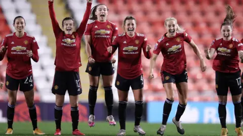 Manchester United Women celebrate the shootout win over Manchester City