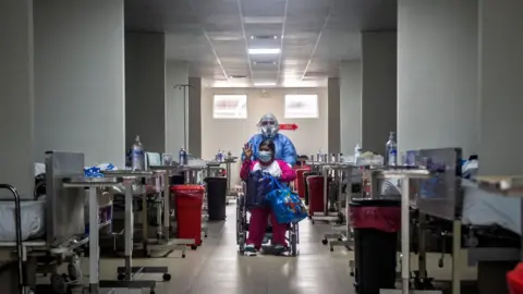 Getty Images Covid patient wheeled out of hospital in Peru