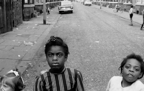 Daniel meadows three girls edge into street shot