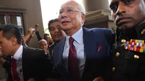 AFP/ Getty Images  Former Malaysian prime minister Najib Razak (C) arrives for a court appearance at the Duta court complex in Kuala Lumpur on 4 July 2018