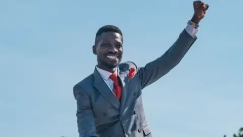 Bobi Wine raising his fist