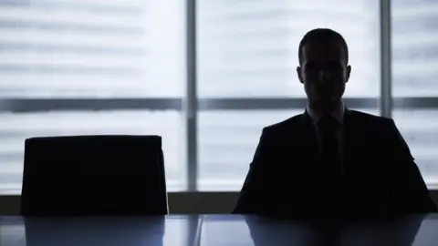 Getty Images Stock photo: Silhouette of a man in an office meeting room