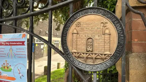 BBC a crest on a park gate showing the Bridgwater emblem