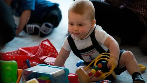 Getty Images George playing with toys