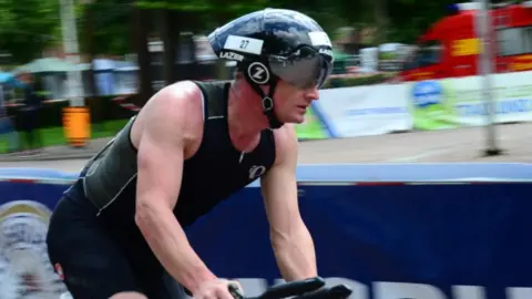 Stuart Gillett A man on a bike wearing a black helmet