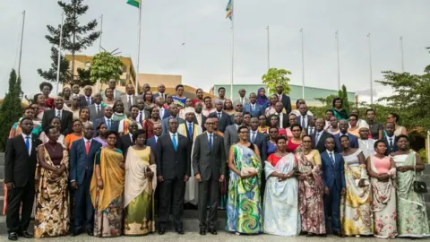 Getty Images Rwandan President Paul Kagame with 80 new MPs in September 2018