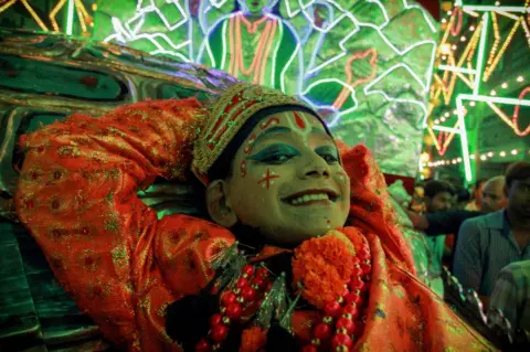 BBC An actor grinning at last year's Ramlila.