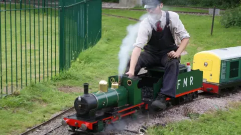 Fancott Miniature Railway Man rides one of the trains