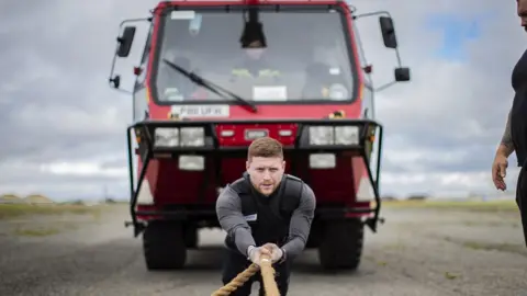 Patrick Dickens Ethan pulling a heavy truck during training