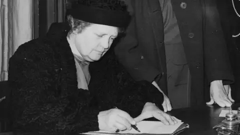 Getty Images Lady Rhondda, Margaret Mackworth, signs petition on women peers, 1947