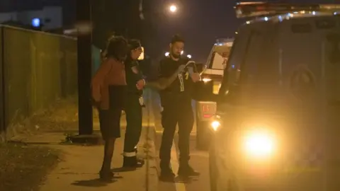 EPA Police outside an industrial compound in the suburb of Woolner where some of the shootings took place