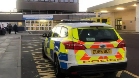 BBC A police car outside Basildon Hospital