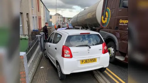 Dylan Jones A car on the pavement following a collision with a truck on the A487