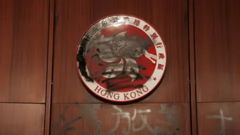 AFP The Hong Kong emblem is spray painted