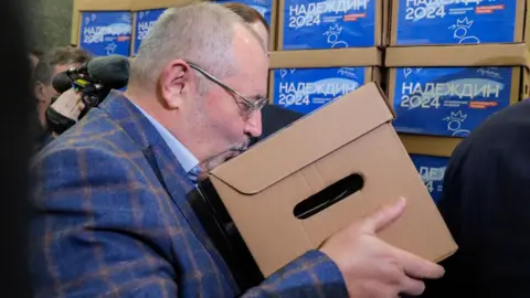 EPA Boris Nadezhdin kisses a box with documents