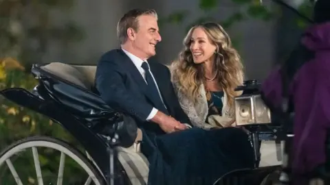 Getty Images Chris Noth (L) and Sarah Jessica Parker are seen sitting in a carriage while filming And Just Like That...